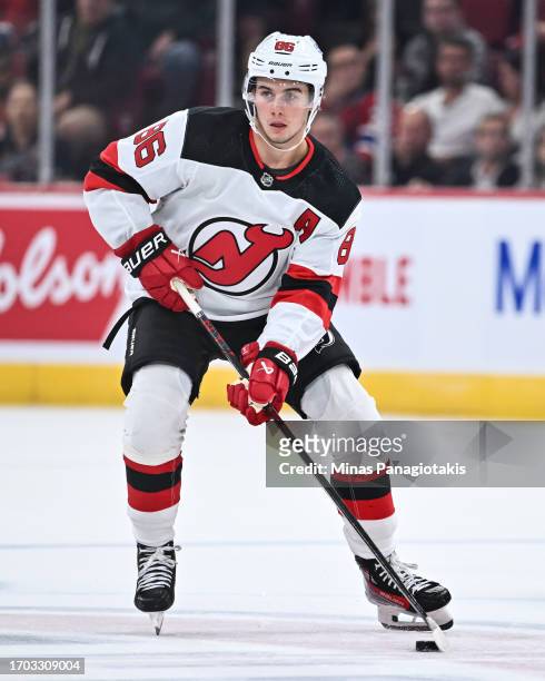 Jack Hughes of the New Jersey Devils skates the puck during the first period against the Montreal Canadiens at the Bell Centre on September 25, 2023...
