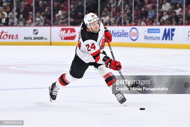 Colin Miller of the New Jersey Devils takes a shot during the first period against the Montreal Canadiens at the Bell Centre on September 25, 2023 in...