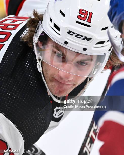 Dawson Mercer of the New Jersey Devils prepares to take a faceoff during the third period against the Montreal Canadiens at the Bell Centre on...