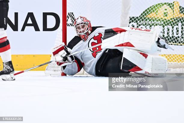 Goaltender Keith Kinkaid of the New Jersey Devils lays on the ice during the third period against the Montreal Canadiens at the Bell Centre on...