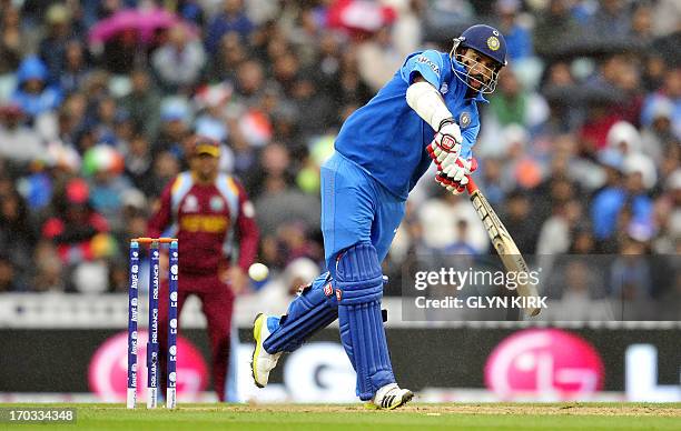 India's Shikhar Dhawan plays a shot during the 2013 ICC Champions Trophy One Day International cricket match between India and West Indies at The...