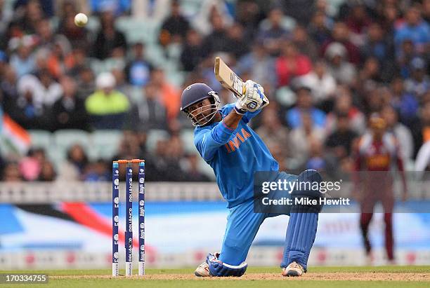 Dinesh Karthik of India smashes a boundary to reach his half centurynand win the match during the ICC Champions Trophy Group B match between India...