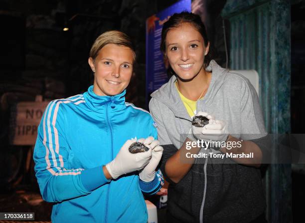 Kirsten Flipkens of Belgium and Laura Robson of Great Britain pose with Indian Spotted Turtles at the Sea Life Centre during The AEGON Classic Tennis...