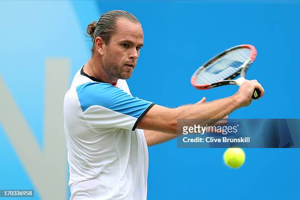 Xavier Malisse of Belgium plays a backhand shot during the Men's Singles second round match against Juan Martin Del Potro of Argentina on day two of...