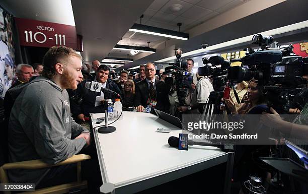 Patrick Kane of the Chicago Blackhawks talks with reporters during the 2013 Stanley Cup Final Media Day at the United Center on June 11, 2013 in...