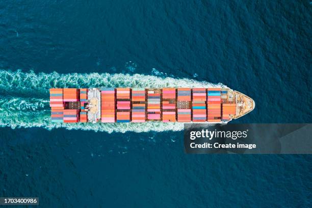 aerial top view container cargo ship full speed with beautiful wave pattern carrier container on the sea for business logistics, import export, shipping or freight transportation. - full elevator stock pictures, royalty-free photos & images