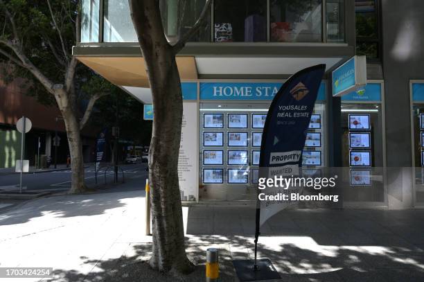 Properties for sale are displayed in the window of a real estate agent in the Docklands precinct of Melbourne, Australia, on Monday, Oct. 2, 2023....