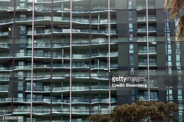 An apartment block reflected in the windows of an office building in the Docklands precinct of Melbourne, Australia, on Monday, Oct. 2, 2023....