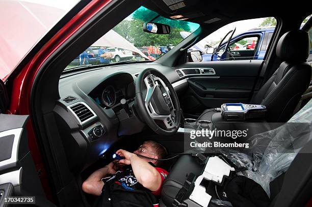 Student works under the dash of a Ford Motor Co. Explorer at the National Finals of the Annual Ford/AAA Student Auto Skills Competition at the Ford...