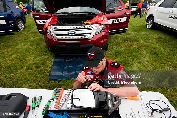 Student repairs the mirror of a Ford Motor Co. Explorer at the National Finals of the Annual Ford/AAA Student Auto Skills Competition at the Ford...