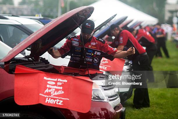 Students work under the hoods of Ford Motor Co. Explorers at the National Finals of the Annual Ford/AAA Student Auto Skills Competition at the Ford...