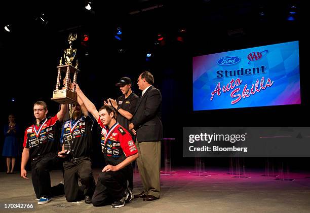 The team from Vale High School, in Vale, Oregon, hold up their first place trophy at the National Finals of the Annual Ford/AAA Student Auto Skills...