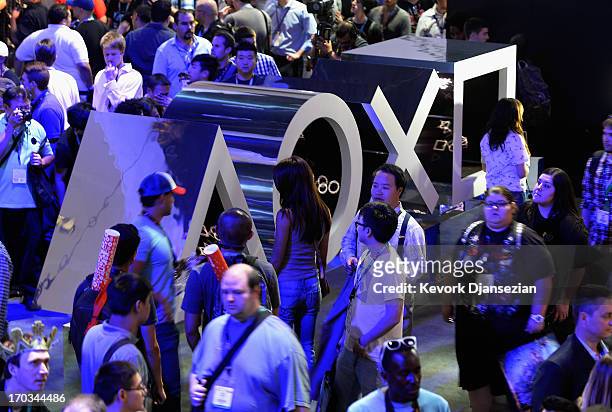 Gamers walk in the Sony Playstation booth durng the Electronics Expo 2013 booth at the Los Angeles Convention Center on June 11, 2013 in Los Angeles,...