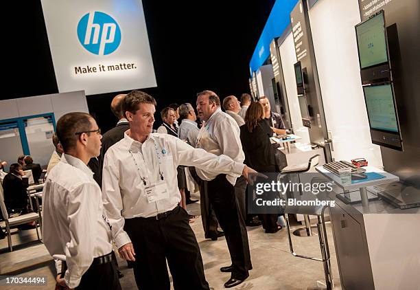 Attendees speak during the HP Discover 2013 conference in Las Vegas, Nevada, U.S., on Tuesday, June 11, 2013. Hewlett-Packard Co. Unveiled software...