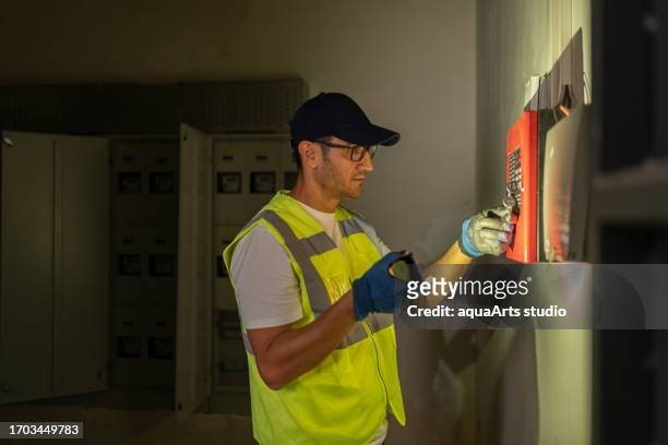 male electrician working at power plant electric energy station - turbine hall stock pictures, royalty-free photos & images