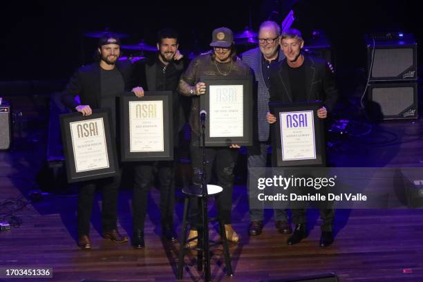 Hunter Phelps, Ben Johnson, HARDY, NSAI President, Steve Bogard and Ashley Gorley pose onstage during the NSAI 2023 Nashville Songwriter Awards at...