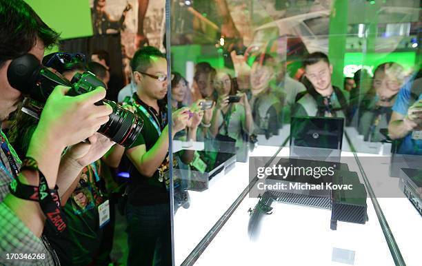 Attendees look at the new Microsoft Xbox 360 at the 2013 E3 Electronic Entertainment Expo at Los Angeles Convention Center on June 11, 2013 in Los...