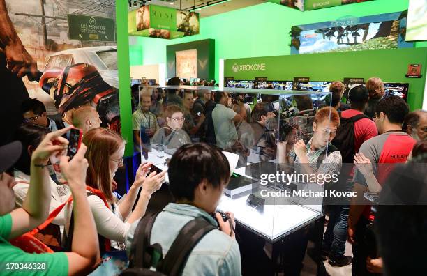 Attendees look at the new Microsoft Xbox 360 at the 2013 E3 Electronic Entertainment Expo at Los Angeles Convention Center on June 11, 2013 in Los...