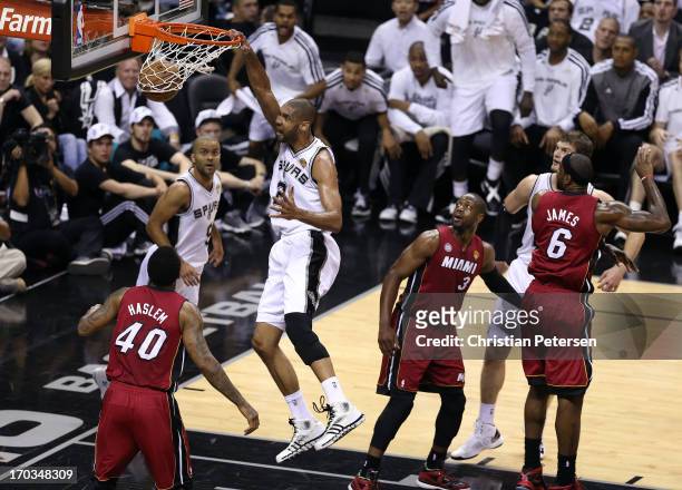 Tim Duncan of the San Antonio Spurs dunks the ball against Udonis Haslem of the Miami Heat in the first quarter during Game Three of the 2013 NBA...