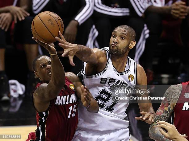 Mario Chalmers of the Miami Heat goes up for a shot against Tim Duncan of the San Antonio Spurs in the first half during Game Three of the 2013 NBA...