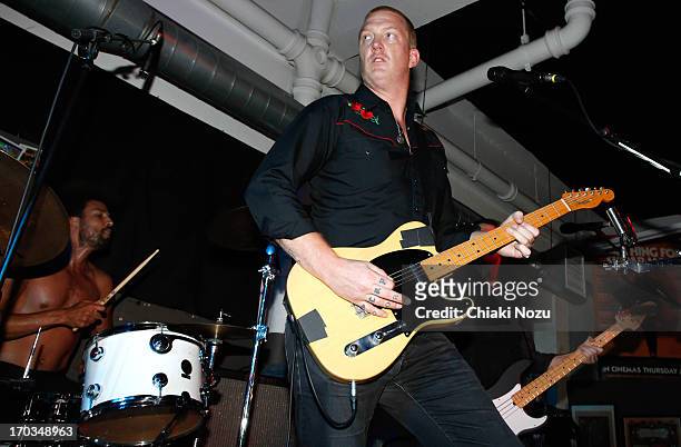 Jon Theodore and Josh Homme of Queens of the Stone Age perform at Rough Trade East on June 11, 2013 in London, England.