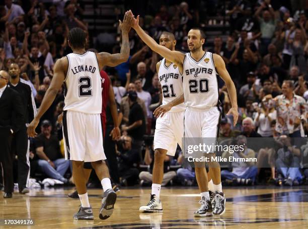 Manu Ginobili and Kawhi Leonard of the San Antonio Spurs celebrate in the first half while taking on the Miami Heat during Game Three of the 2013 NBA...