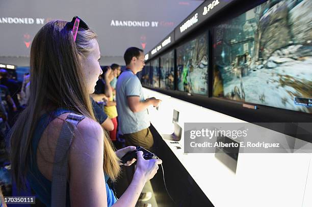 Fan enjoys the Sony Play Station 4 exhibit on the opening day at the E3 Gaming and Technology Conference at the Los Angeles Convention Center on June...