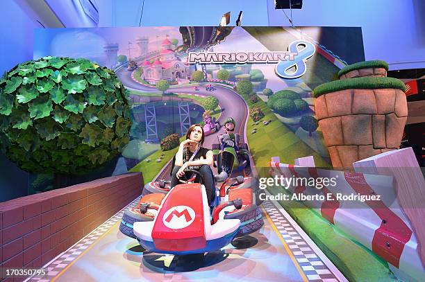 Fans enjoy the Nintendo Mariokart 8 display at the E3 Gaming and Technology Conference at the Los Angeles Convention Center on June 11, 2013 in Los...