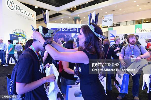 Fan gets free merchandise at the E3 Gaming and Technology Conference at the Los Angeles Convention Center on June 11, 2013 in Los Angeles, California.