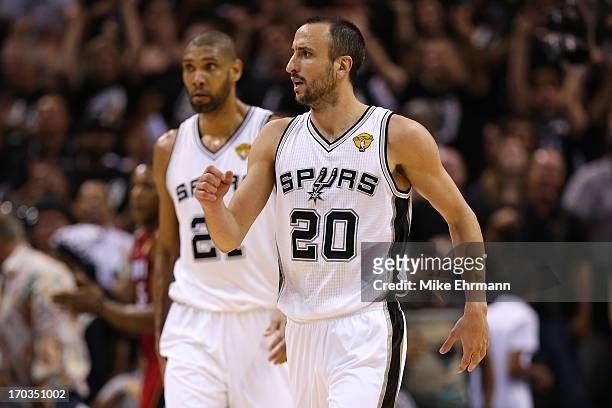 Manu Ginobili and Tim Duncan of the San Antonio Spurs celebrate in the third quarter while taking on the Miami Heat during Game Three of the 2013 NBA...