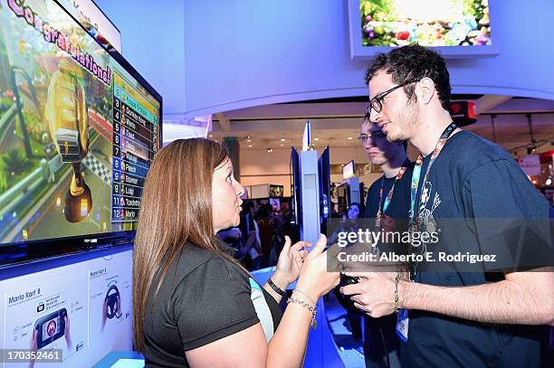 Fan gets instuction on the Mariokart 8 game at the E3 Gaming and Technology Conference at the Los Angeles Convention Center on June 11, 2013 in Los...