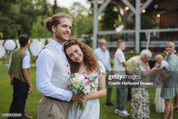portrait of groom and bride from a small garden wedding. - promesas de matrimonio fotografías e imágenes de stock