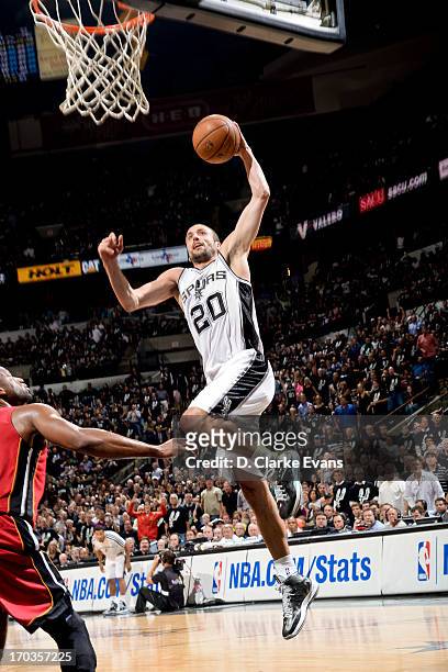 Manu Ginobili of the San Antonio Spurs dunks against Dwyane Wade of the Miami Heat during Game Three of the 2013 NBA Finals on June 11, 2013 at AT&T...