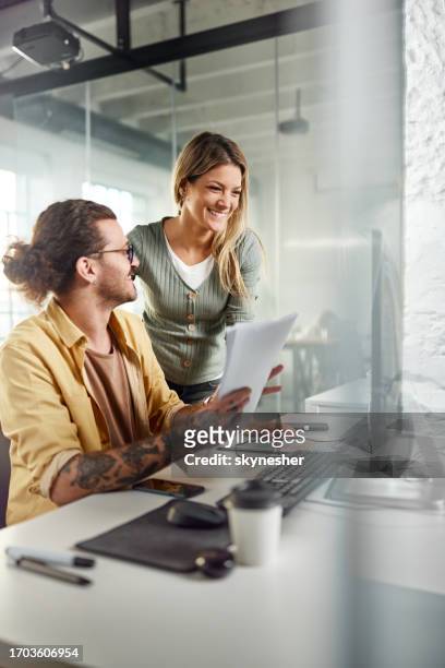 happy programmers working on pc and reports in the office. - graphic artist stock pictures, royalty-free photos & images