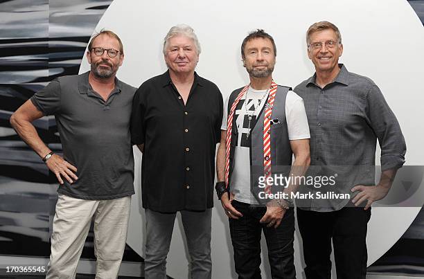 Bad Company members drummer Simon Kirke, guitarist/songwriter Mick Ralphs and singer/songwriter Paul Rodgers pose in the museum with GRAMMY Museum...