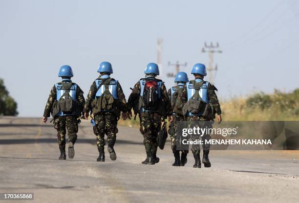 United Nations peacekeepers from the Philippines cross the Israeli army crossing of Quneitra between Syria to the Israeli annexed Golan Heights on...