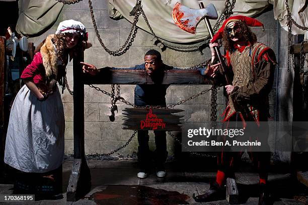 Actor Marlon Wayans poses with performers ahead of the release of his new film 'A Haunted House' at London Dungeon on June 12, 2013 in London,...