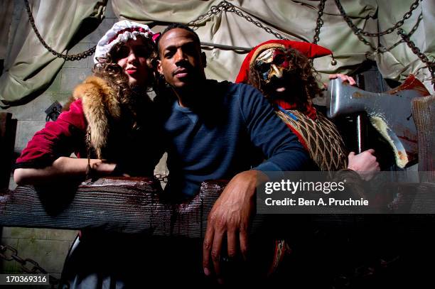 Actor Marlon Wayans poses with performers ahead of the release of his new film 'A Haunted House' at London Dungeon on June 12, 2013 in London,...