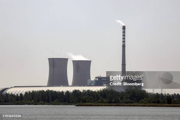 View of A thermal power plant near a floating solar farm of Sungrow Power Supply Co., not pictured, China, on Monday, May 15, 2023. The installation...
