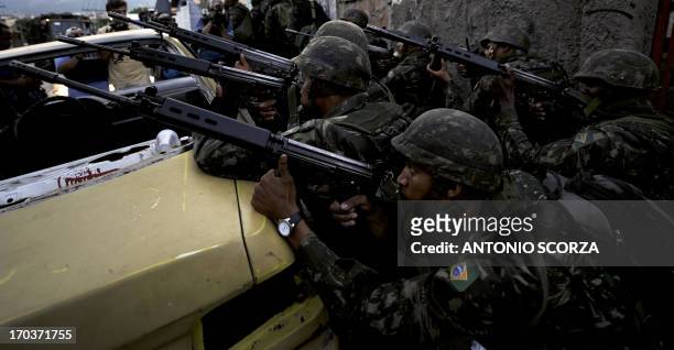 Brazilian Army soldiers remain in their positions preparing an operation at Morro do Alemao shantytown on November 27, 2010 in Rio de Janeiro,...