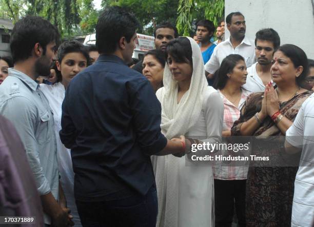 Indian fashion designer Manish Malhotra consoles Priyanka Chopra as her mother Madhu Chopra and brother Siddharth looks on during funeral of her...