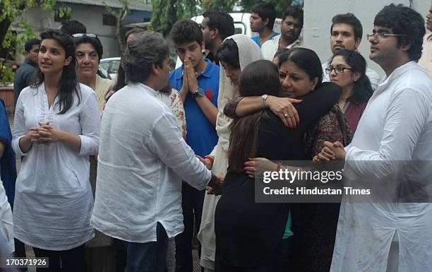 Bollywood film maker Vishal Bhardwaj consoles Priyanka Chopra as her mother Madhu Chopra and brother Siddharth looks on during funeral of her father...