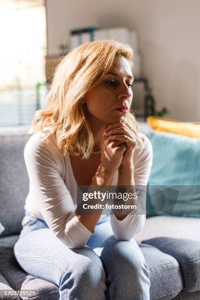 woman overwhelmed by anxiety struggling with her mental health and negative emotions - emotional series stock pictures, royalty-free photos & images