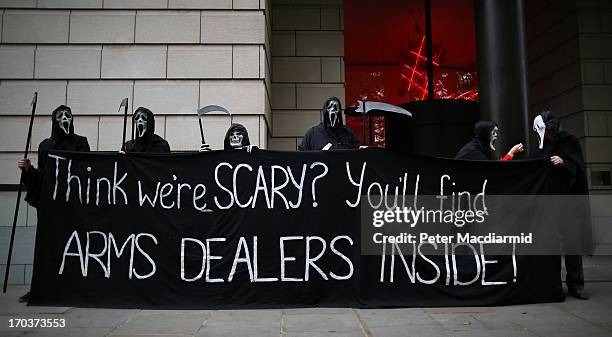 Protesters dressed as the Grim Reaper stand outside arms manufacturer BAe Systems on June 12, 2013 in London, England. Protests are expected to take...