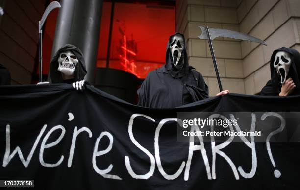 Protesters dressed as the Grim Reaper stand outside arms manufacturer BAe Systems on June 12, 2013 in London, England. Protests are expected to take...