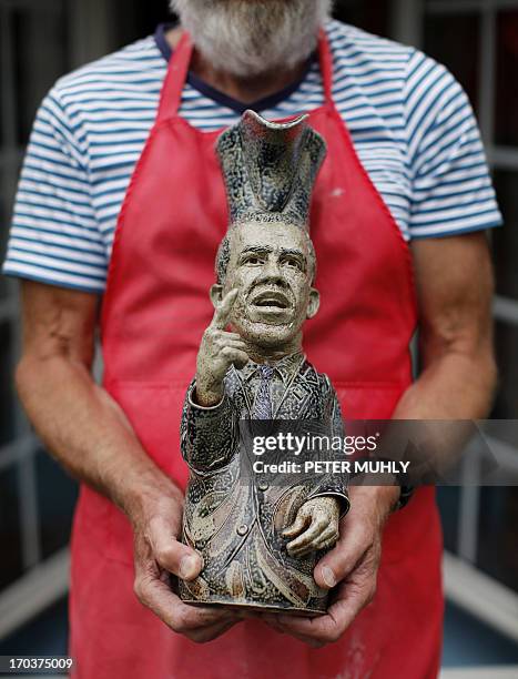 Peter Meanley, Head of Ceramics at the University of Ulster, poses for pictures with a Toby jug depicting US President Barack Obama outside his...