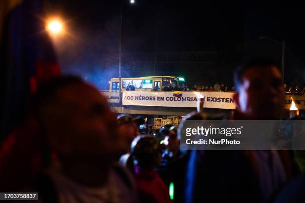 Sign in support of Colombia's military and police forces is placed in an overpass as government oposers take part in a demonstration against the...