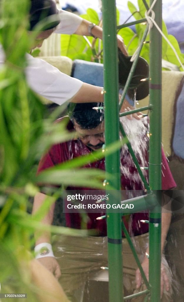 TOPSHOT-PHILIPPINES-ESTRADA-SHRINE-BATH-1