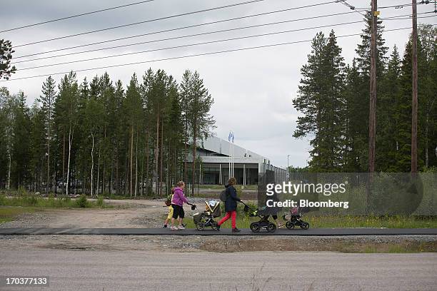 Pedestrians pass the new data storage facility for Facebook Inc. Near the Arctic Circle in Lulea, Sweden, on Wednesday, June 12, 2013. The data...