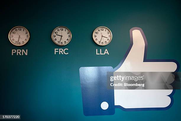 Facebook "Like" button sits on a wall display beside clocks inside Facebook Inc.'s new data storage center near the Arctic Circle in Lulea, Sweden,...